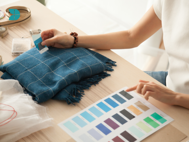 fashion designer comparing textiles and fabrics to create a garment.