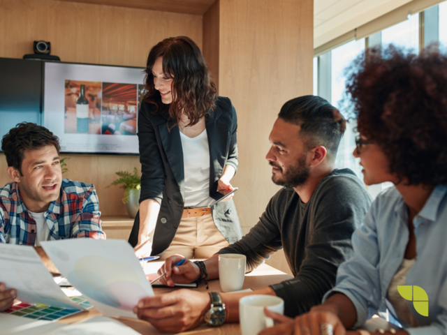 A group of people having a meeting to brainstorm and discuss new strategies, and findings.