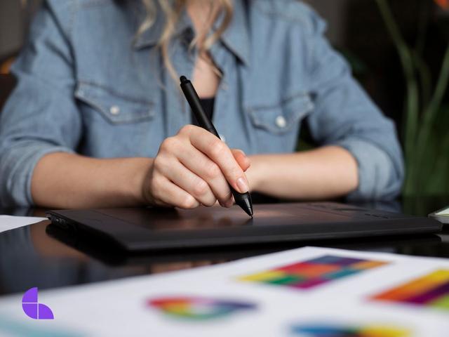 young female logo designer working on a graphic tablet