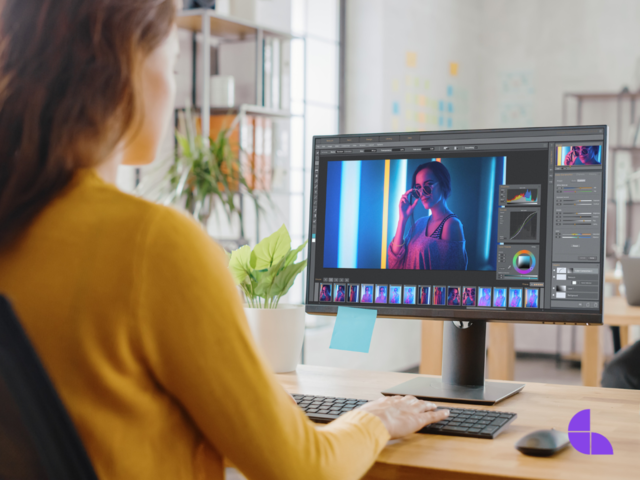 Graphic designer editing a photograph using a editing software on desktop.