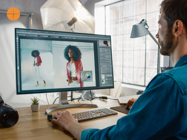 A photographer editing a photograph on editing software such as Lightroom or Photoshop.