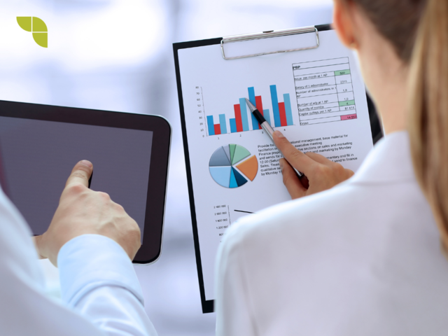 Data analyst analysing a report with numbers and charts.