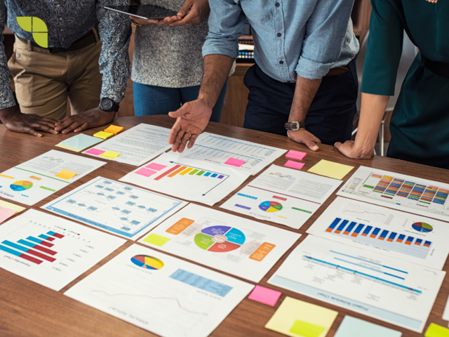 Group of data analysts having a meeting around data analysis and the findings for the business.