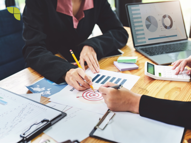 Two marketers discussing and analysing a report related to target audience.